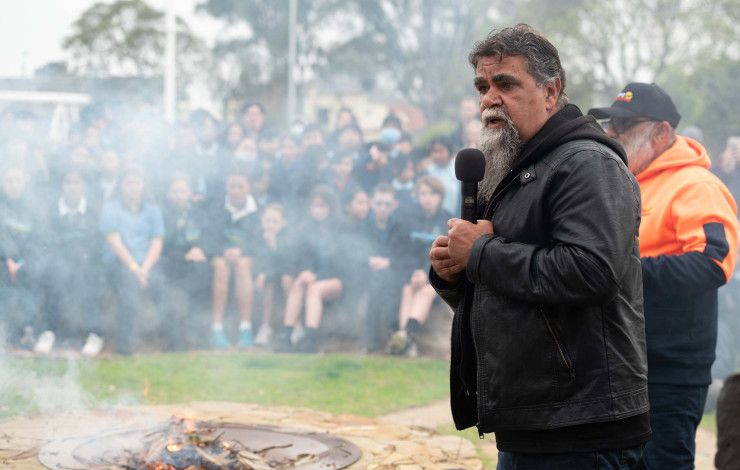 an Aboriginal man speaking at a smoking ceremony