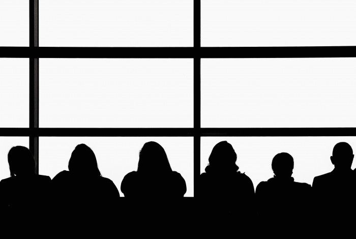 silhouettes of people against a window