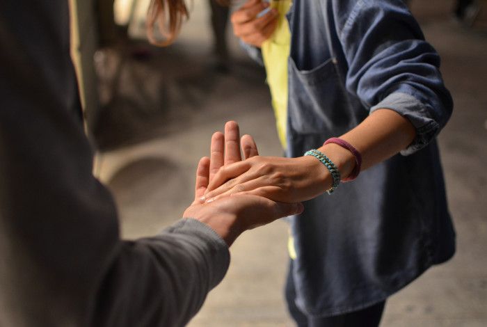 two people connecting via touching hands